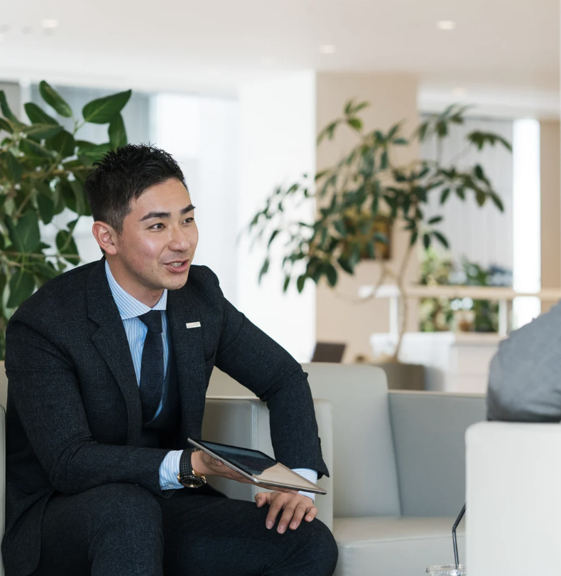 Sales rep at a car dealership holding an ipad